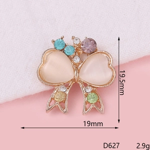 Macro shot of D627 bow-shaped alloy charm with colorful rhinestones and opal hearts