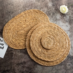Japanese style handmade woven straw placemat set for heat insulation on dark stone table