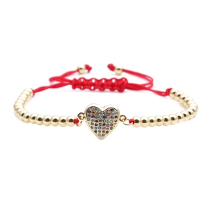 Gold beaded bracelet with heart pendant and adjustable red woven cord for women