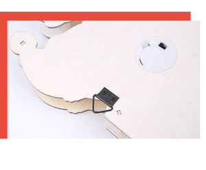 Detail of the wooden ornament back featuring a black metal hook and white battery compartment