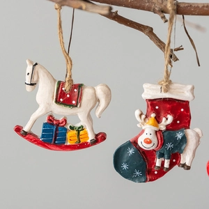 Vintage resin Christmas ornaments with rocking horse and reindeer stocking hanging on a branch