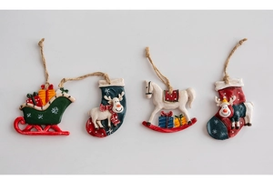 Detailed view of vintage resin Christmas tree ornaments including sled and reindeer styles