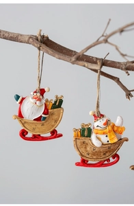 Hanging resin Christmas ornaments featuring Santa and Snowman on sleds with twine