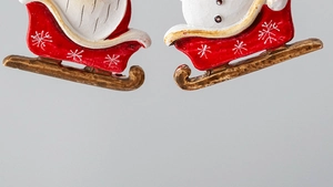Detailed macro view of resin Christmas sleigh base with hand-painted snow patterns