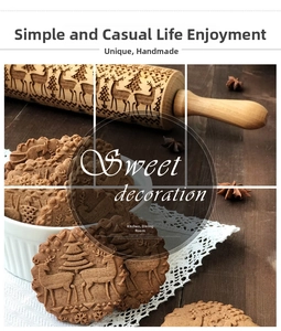 Detailed engraving of reindeer and snowflake patterns on a wooden Christmas rolling pin