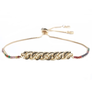 Macro view of gold chain bracelet with micro-pave black zircon and colorful gemstones