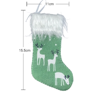 Small green Christmas stocking with white reindeer print and plush cuff, 11x15.5cm size