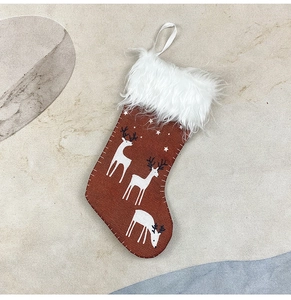 Close-up of a small Christmas stocking with reindeer patterns and soft faux fur cuff