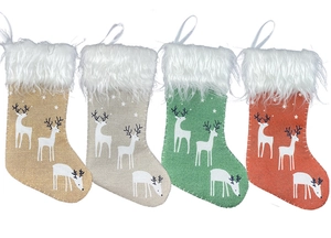 Detail of four colorful linen Christmas stockings with white faux fur trim and hanging loops