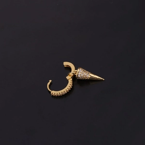 Detail of gold huggie hoop earring with a sparkling zircon encrusted cone pendant