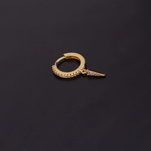 Close-up of golden hoop earring with a tapered cone pendant featuring zircon inlay