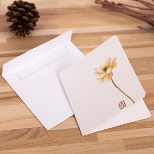Artistic Chinese style lotus greeting card with envelope on a rustic wooden desk setup