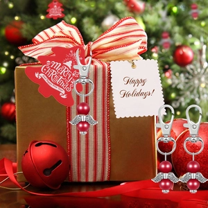 Detail of red bead angel wing ornament with silver metal charms for Christmas tree decor