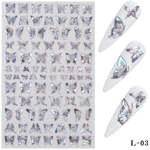 Macro shot of 3D holographic silver butterfly nail art stickers on white manicure tips