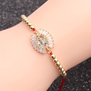 Gold-plated evil eye chain bracelet with colorful cubic zirconia and red elastic cord