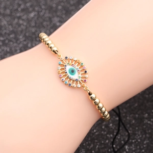 Gold beaded bracelet featuring a micro-pave zircon Evil Eye charm with blue enamel detail