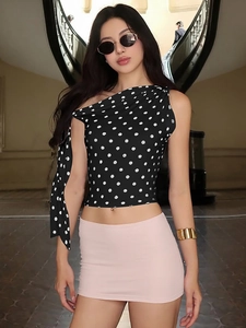 Women's black and white polka dot one-shoulder sleeveless crop top with side tie detail