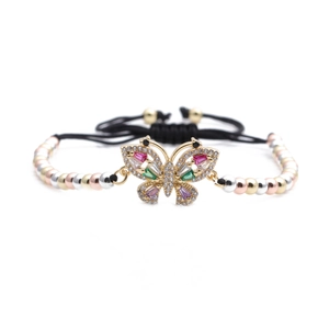 Detail of copper butterfly bracelet with colorful cubic zirconia and braided cord