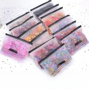 Macro detail of multi-colored high-elastic hair ties in semi-transparent zipper bags