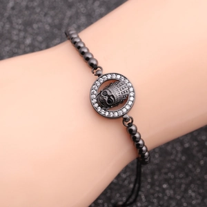 Skull bracelet with dark gray beads and crown skull pendant featuring zircon details