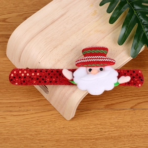 Close-up of a festive red sequin Christmas slap bracelet with a 3D Santa Claus doll