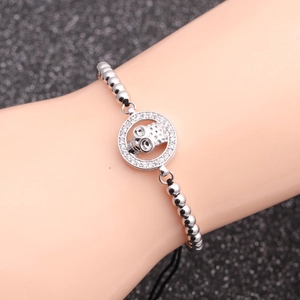 Skull bracelet with micro-pave cubic zirconia charms and adjustable black woven rope