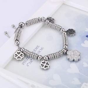 Silver beaded snake chain bracelet featuring sparkling clover charms and pavé crystal accents