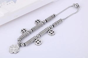 Detail of silver clover bracelet with white zircons and adjustable snake chain strap