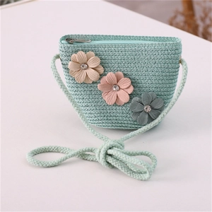 Detail of mint green woven girls' bag with floral appliques and metal zipper