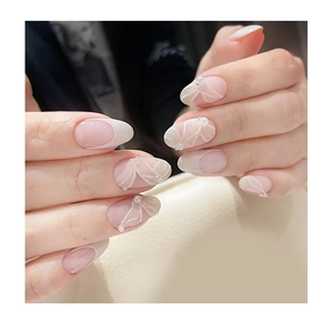 French tip artificial nails with 3D white floral patterns and elegant mini pearls