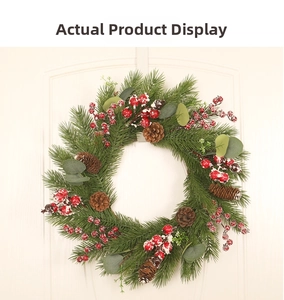 Detail of Christmas wreath with snowy red berries, pine cones and eucalyptus on wood