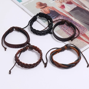 Detail of 5-piece multilayer braided leather bracelets set in black and brown tones