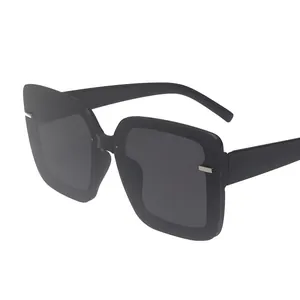 Fashionable oversized square black sunglasses with metal stud accents and dark gray lenses