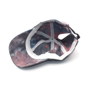 Macro shot showing internal stitching and ponytail opening of the tie-dye baseball cap