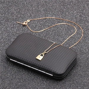 Close-up of rose gold necklace with zircon-set lock pendant in a black gift box