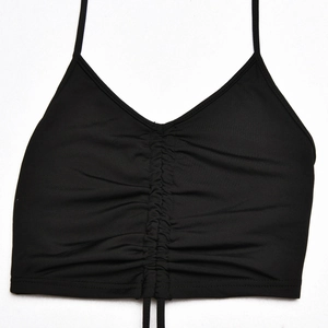 Close-up of black ruched crop top with adjustable drawstrings and thin straps