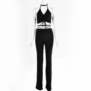 Detail of black halter top with wrap-around waist ties and matching high-waisted trousers