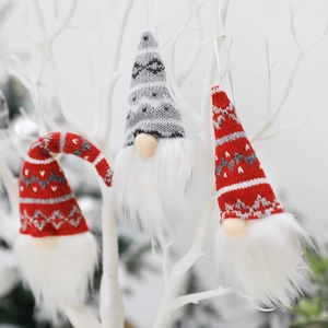 Three-piece knitted Christmas gnome ornaments hanging on decorative white branches