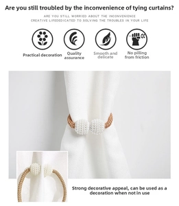 Detail of elegant magnetic curtain tieback with white pearl spheres and gold braided rope
