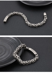 Detail of vintage Byzantine style stainless steel chain on black leather background