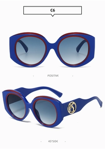 Detail of blue and red frame sunglasses with golden side logo and gradient lenses