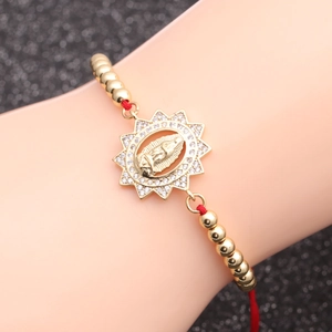 Gold Virgin Mary charm bracelet with red braided rope and sparkling zircon accents