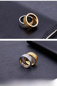 Close-up of gold and silver brushed stainless steel rings with grooved textures