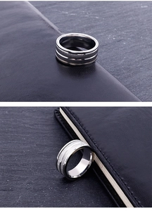 Close-up of men's silver stainless steel ring showing brushed texture and polished edges