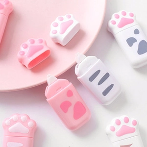 Flat lay of cute cat paw correction tapes in pink and white over a pastel background