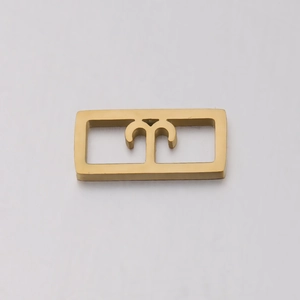 Detailed macro view of golden stainless steel square pendant with cutout zodiac Aries sign