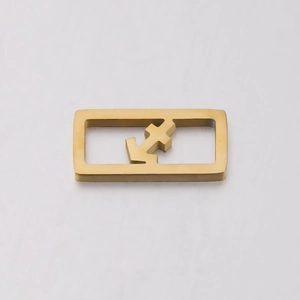 Close-up of golden stainless steel hollow square charm with geometric design on white backdrop