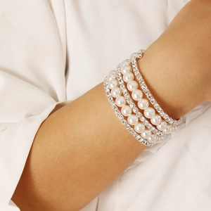 Close-up of multi-layer pearl and rhinestone bracelet worn on wrist for fashion
