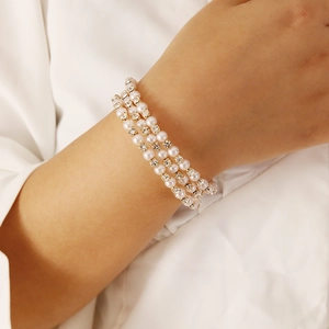 Close-up of triple-layered pearl and rhinestone bracelet on wrist for an elegant look