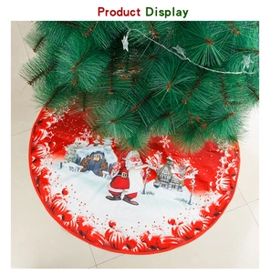 Detail of red Christmas tree skirt featuring Santa and winter house festive prints